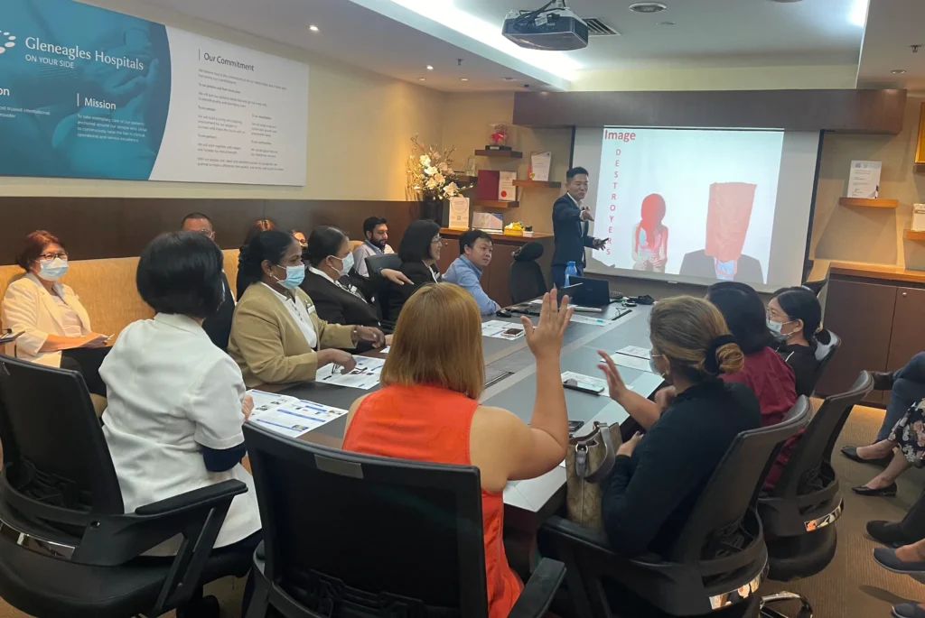 Lionel Lim conducting a professional image and grooming talk for Gleneagles Hospital staff in Singapore